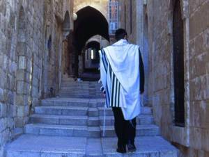 מתפלל יהודי חוזר לביתו לאחר תפילה בכותל. צילם: גיא נוימן